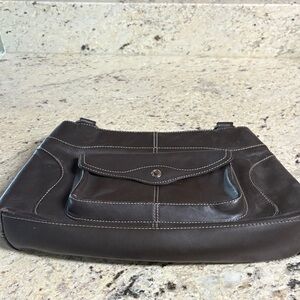 This dark brown purse is made of leather and in great shape.